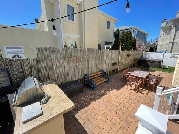 a view of a patio with a dining table and chairs with wooden floor