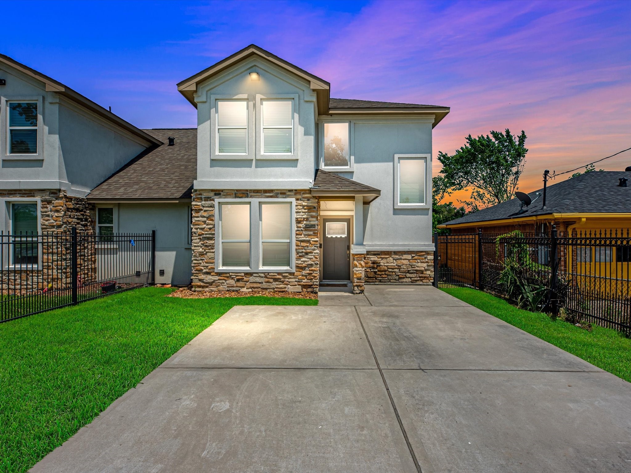 a front view of a house with a yard and garage