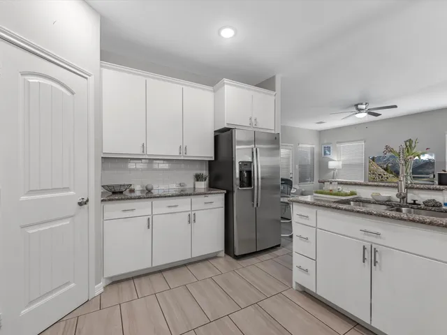 a kitchen with stainless steel appliances granite countertop a refrigerator sink and cabinets