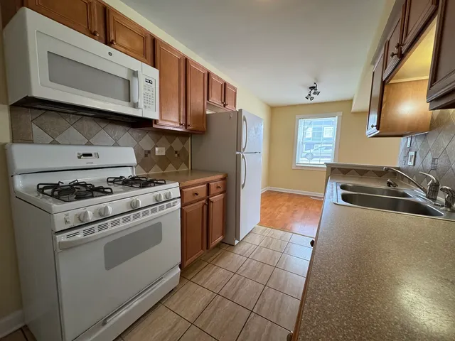 a kitchen with stainless steel appliances granite countertop a stove a microwave and a sink