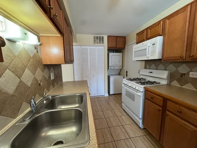 a kitchen with a sink and a stove top oven
