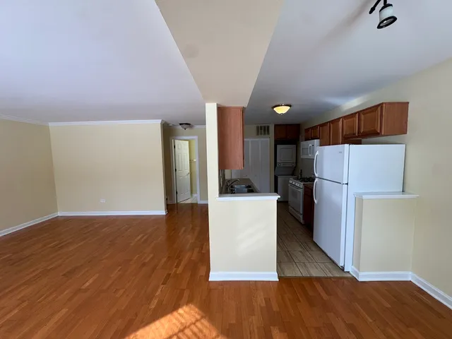a view of kitchen with wooden floor and electronic appliances