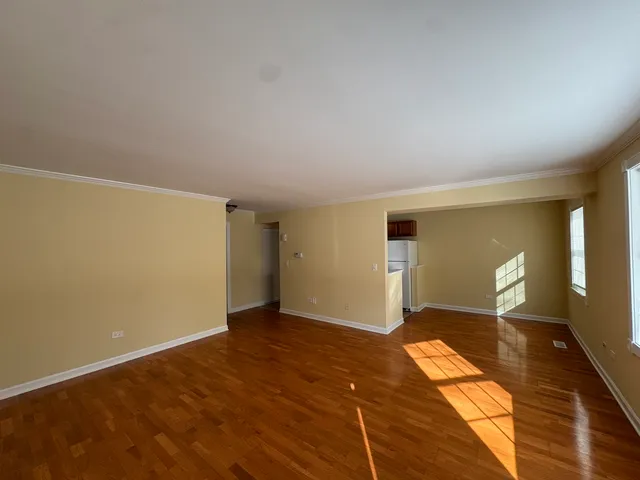 a view of a room with wooden floor and bathroom