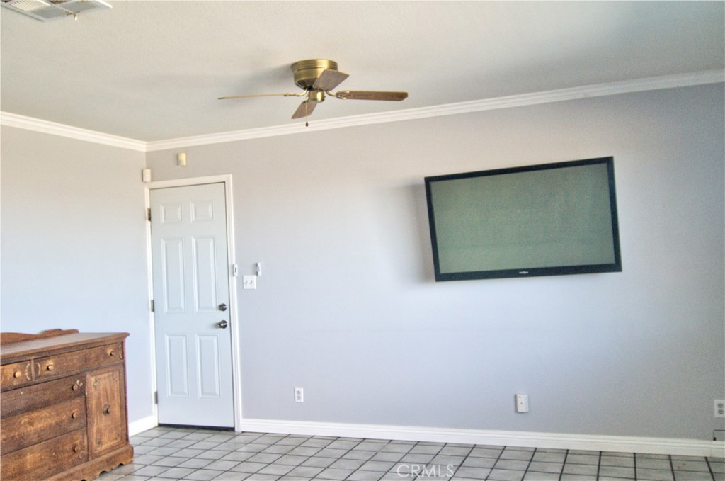 51063 Joshua Tree Road Landers, CA 92285 - Photo 25 of 38 This is the far end of the living room. The door leads into the HUGE attached garage! The garage is the same size as the house. It would be super easy to add a third bedroom out there and the prior owner told me that the HVAC system could easily handle the extra load.
