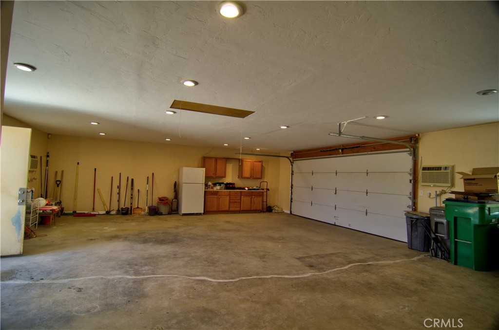 51063 Joshua Tree Road Landers, CA 92285 - Photo 28 of 38 What person doesn't want a huge garage. There are two 240V wall airc onditioners in the garage that can keep it cool.