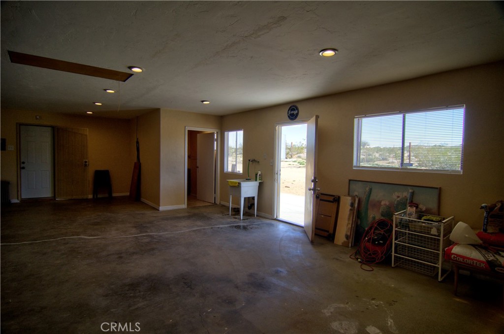 51063 Joshua Tree Road Landers, CA 92285 - Photo 30 of 38 The backdoor from the garage leads out to the backyard.