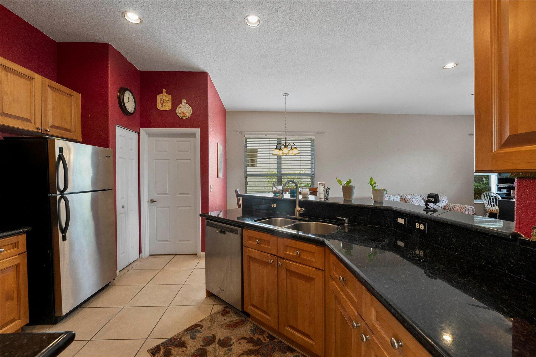 5002 Victoria Circle West Palm Beach, FL 33409 - Photo 11 of 37 a kitchen with stainless steel appliances a sink stove and refrigerator