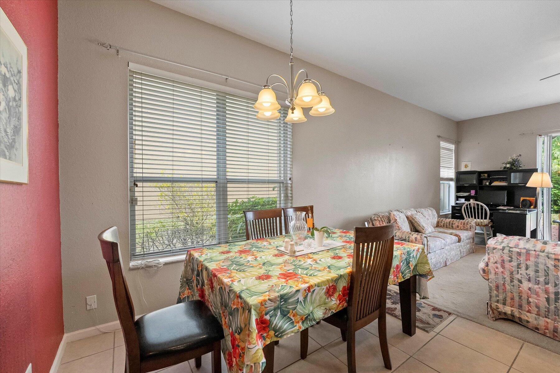 5002 Victoria Circle West Palm Beach, FL 33409 - Photo 14 of 37 a view of a dining room with furniture and window
