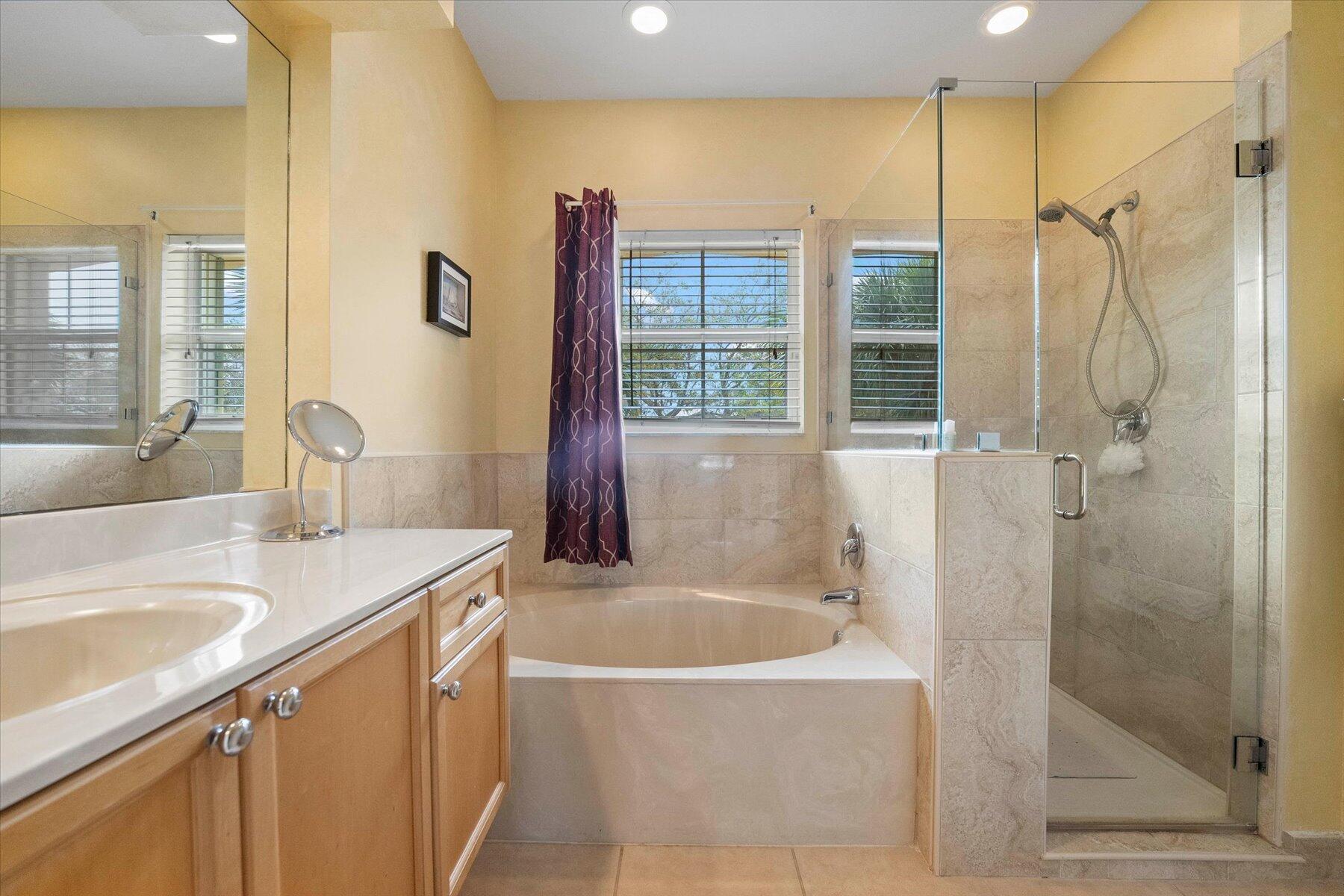 5002 Victoria Circle West Palm Beach, FL 33409 - Photo 21 of 37 a bathroom with a sink a mirror and a bathtub