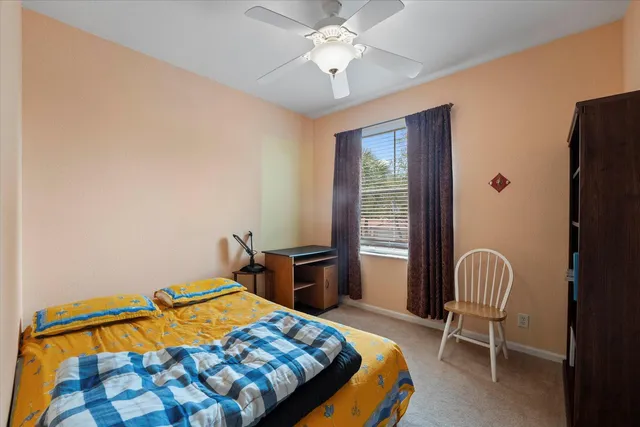 a bedroom with a bed and a chair