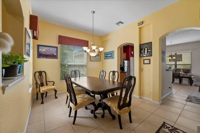 a view of a dining room with furniture and chandelier