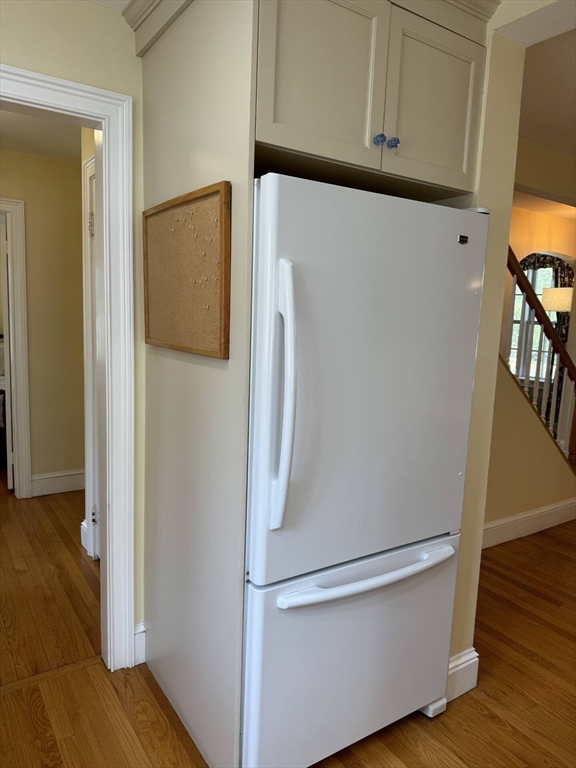 161 Chestnut Street Amherst, MA 01002 - Photo 12 of 41 a white refrigerator freezer and a wooden floor