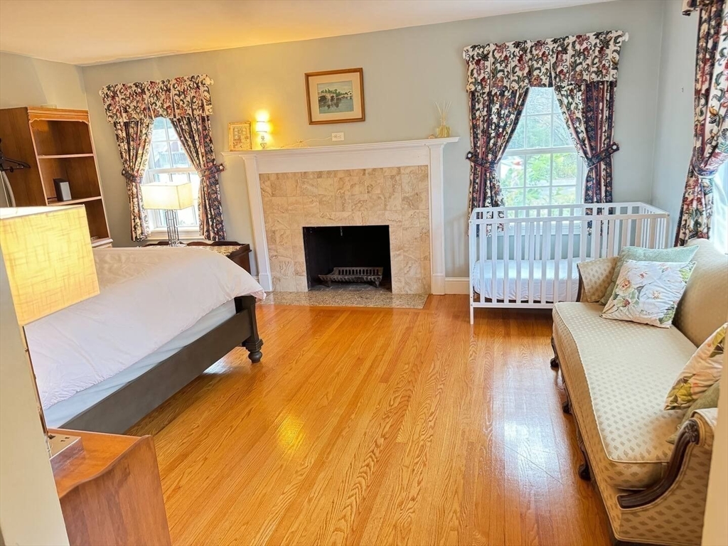 161 Chestnut Street Amherst, MA 01002 - Photo 14 of 41 a spacious bedroom with a bed and a fireplace