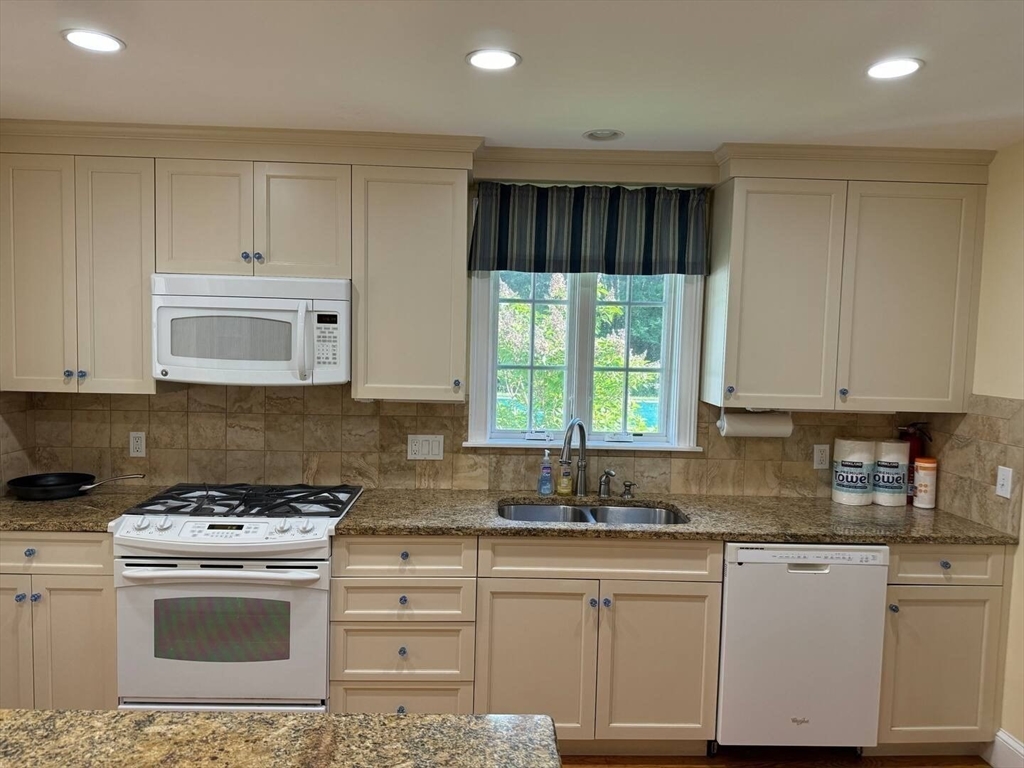 161 Chestnut Street Amherst, MA 01002 - Photo 19 of 41 a kitchen with stainless steel appliances granite countertop a stove a sink and a microwave