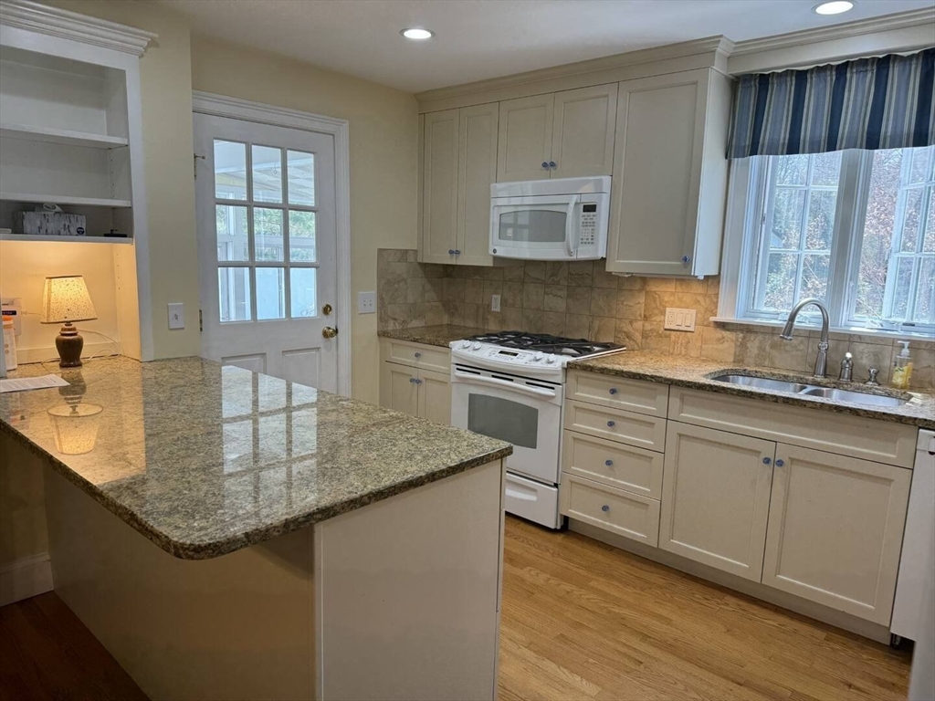 161 Chestnut Street Amherst, MA 01002 - Photo 3 of 41 a kitchen with stainless steel appliances granite countertop a sink stove and cabinets