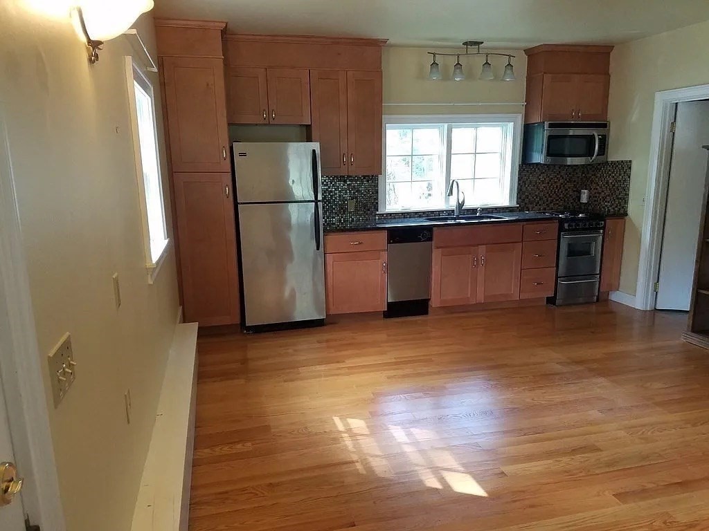 161 Chestnut Street Amherst, MA 01002 - Photo 33 of 41 a kitchen with granite countertop a refrigerator and a stove top oven