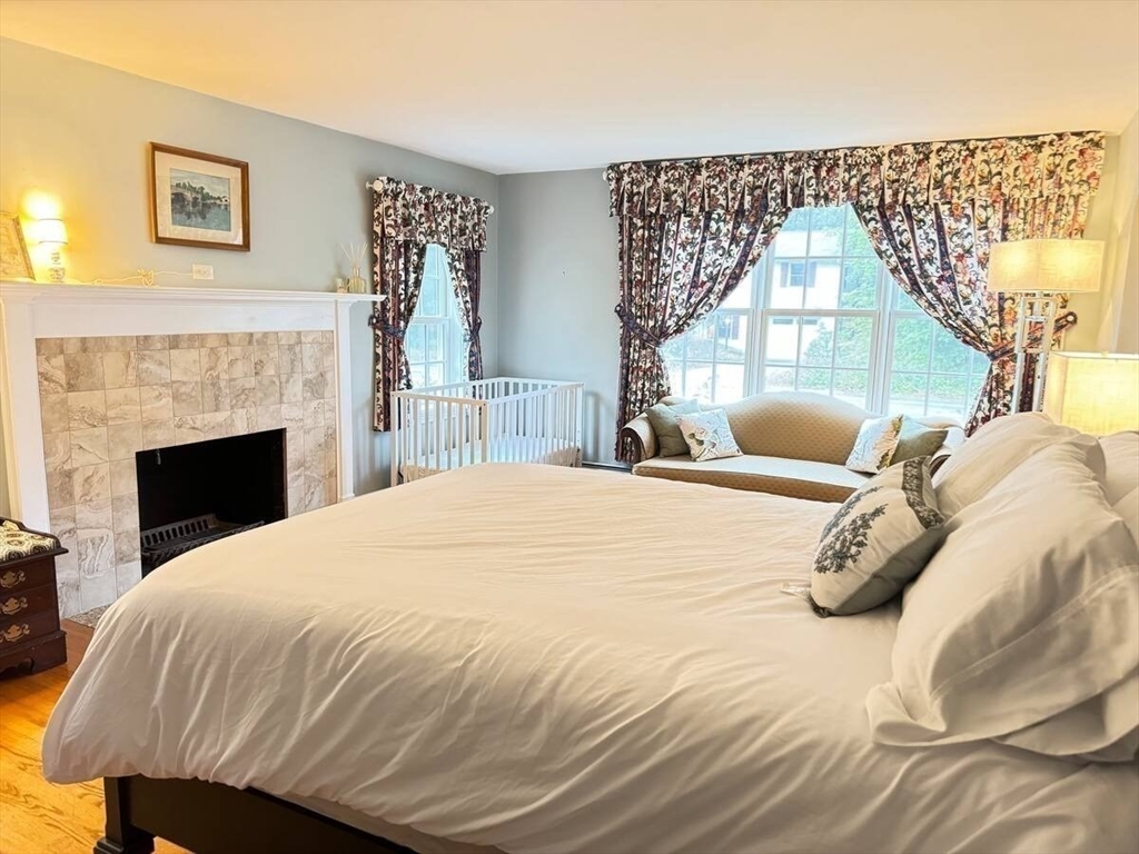 161 Chestnut Street Amherst, MA 01002 - Photo 10 of 41 a bedroom with a large bed and a fireplace