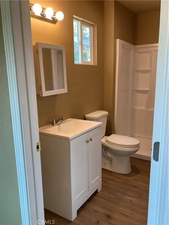 a bathroom with a toilet sink and a mirror