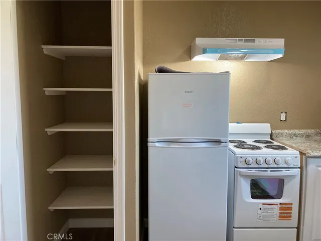 a kitchen with a refrigerator and a stove