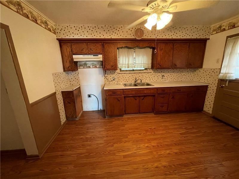 211 South Walnut Street New Castle, PA 16101 - Photo 12 of 18 a view of kitchen with sink and wooden floor