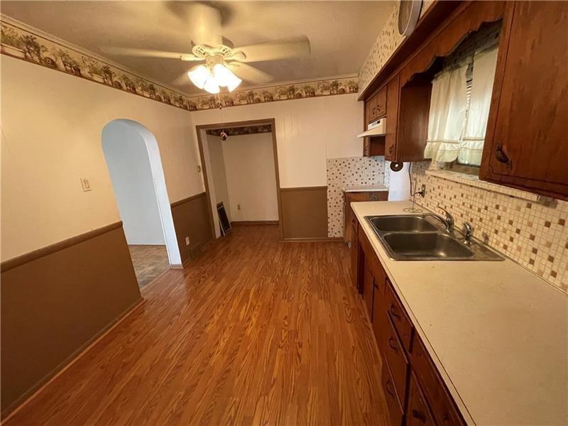 211 South Walnut Street New Castle, PA 16101 - Photo 13 of 18 a kitchen with granite countertop a sink stove and refrigerator