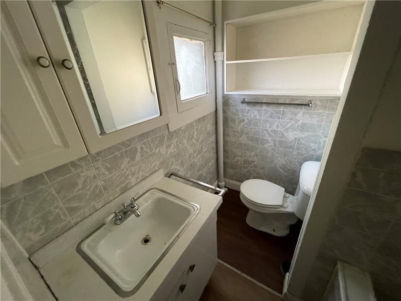 211 South Walnut Street New Castle, PA 16101 - Photo 9 of 18 a bathroom with a sink toilet and shower
