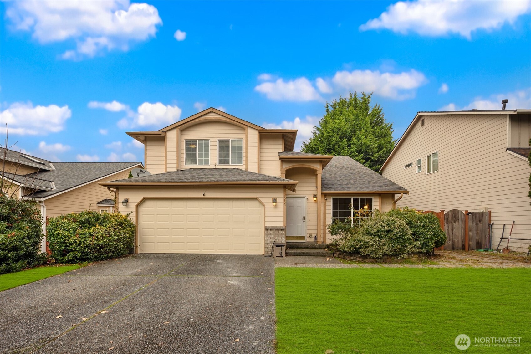 a front view of a house with a yard and garage