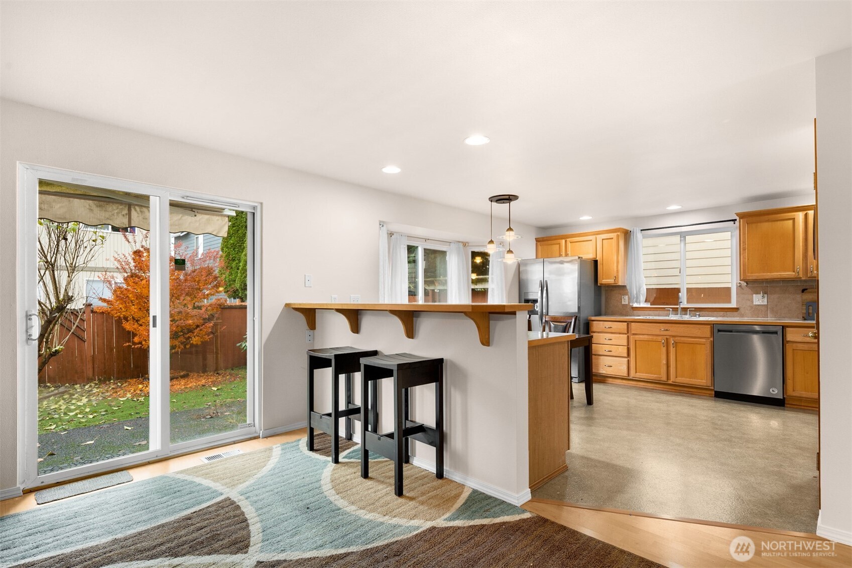 2632 Northeast 24th Court Renton, WA 98056 - Photo 11 of 33 a open kitchen with stainless steel appliances granite countertop a stove top oven a sink and a refrigerator