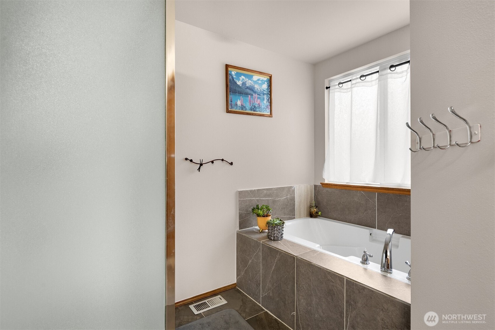 2632 Northeast 24th Court Renton, WA 98056 - Photo 14 of 33 a bathroom with a tub a sink and a window
