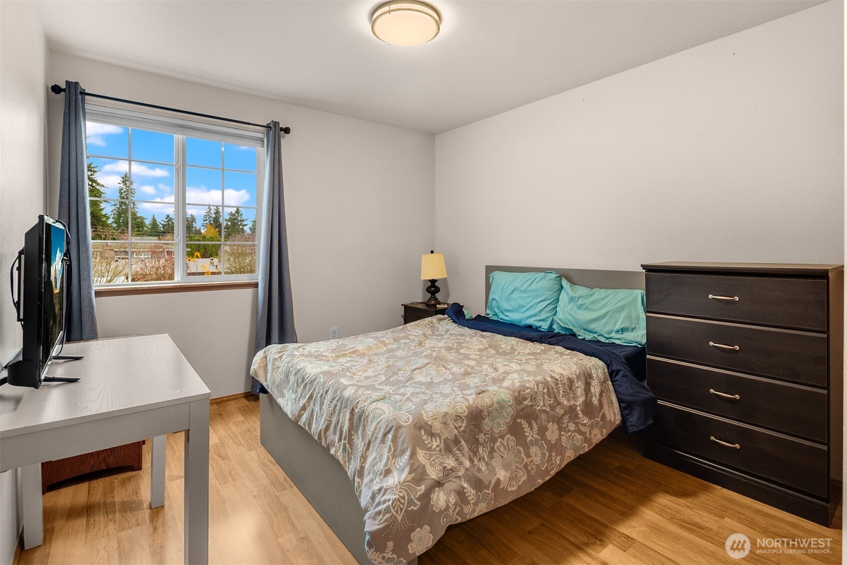 2632 Northeast 24th Court Renton, WA 98056 - Photo 18 of 33 a bedroom with a bed and a flat tv screen on dresser