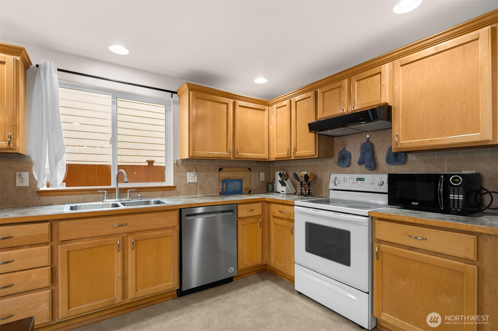 2632 Northeast 24th Court Renton, WA 98056 - Photo 22 of 33 a kitchen with a sink stove and cabinets