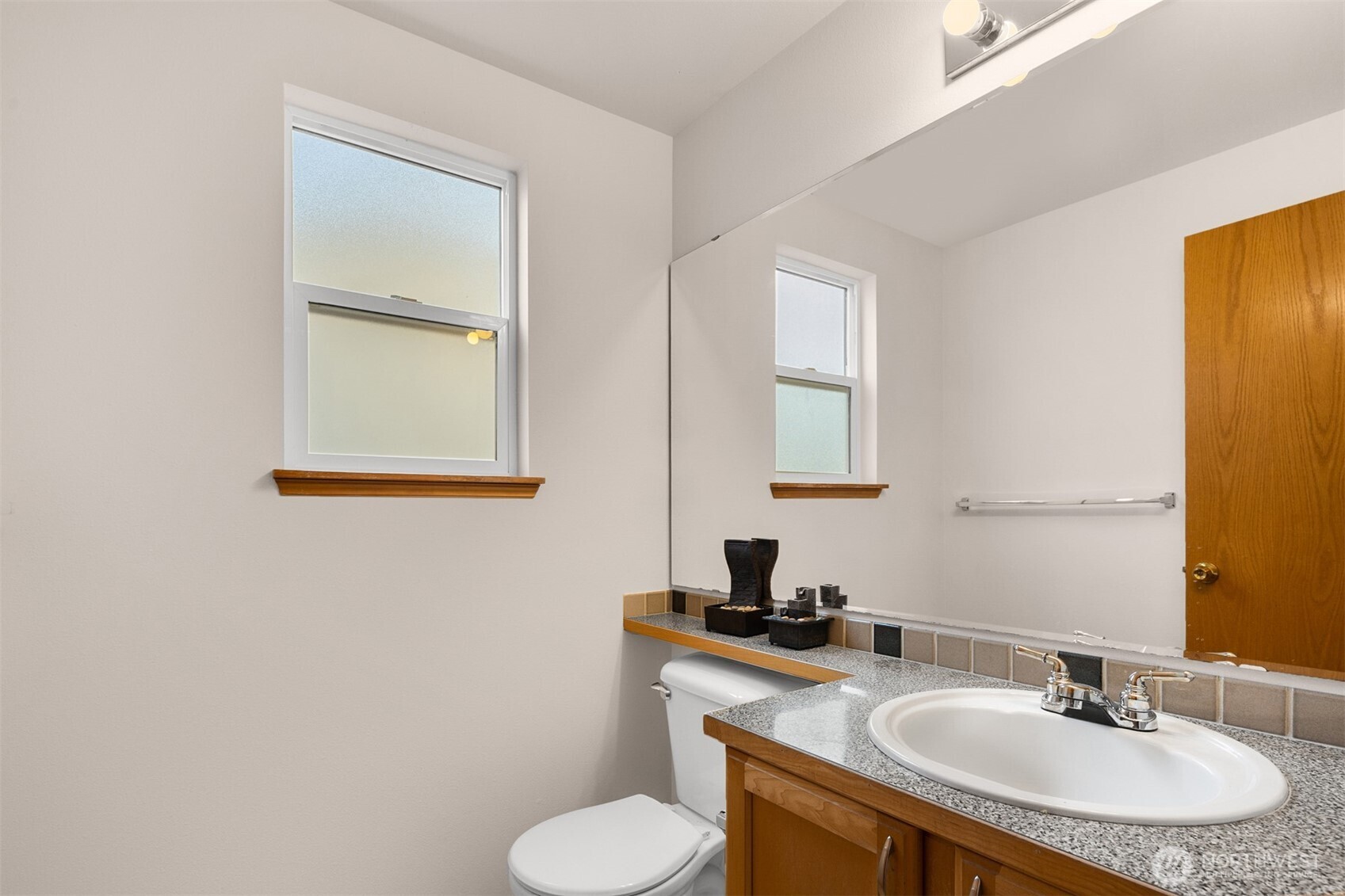 2632 Northeast 24th Court Renton, WA 98056 - Photo 25 of 33 a bathroom with a granite countertop sink toilet and mirror
