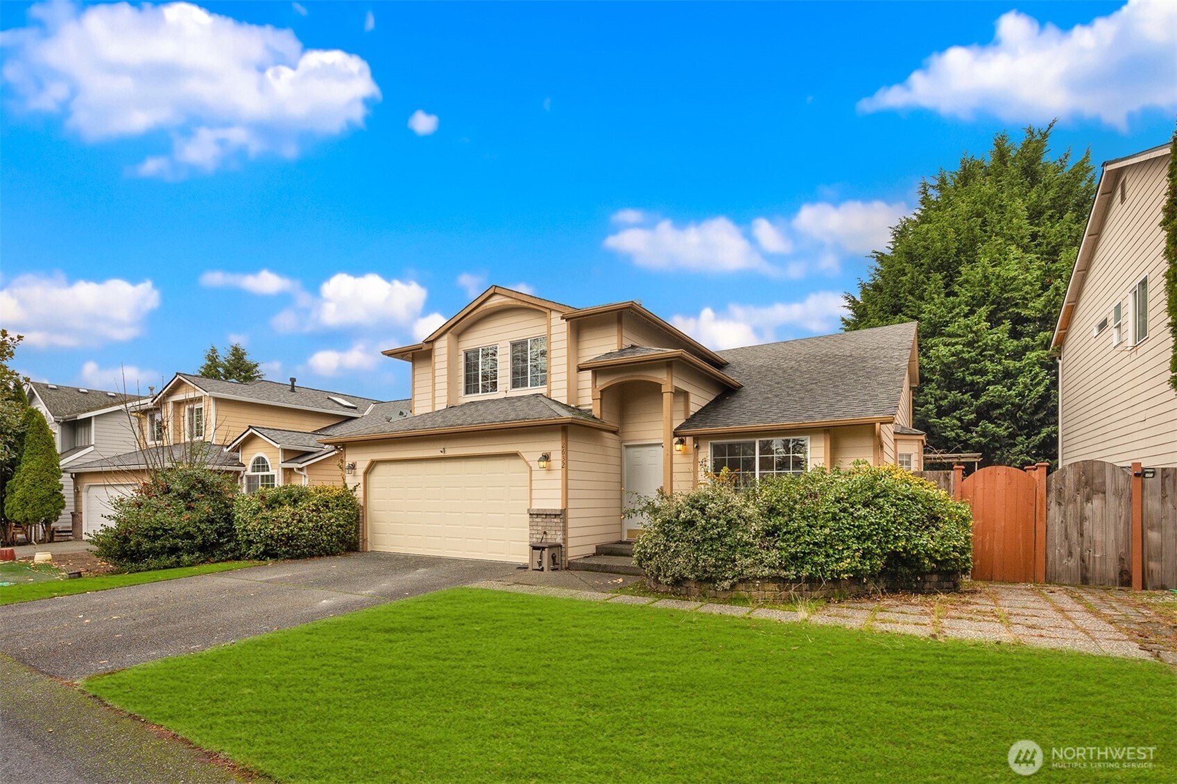 2632 Northeast 24th Court Renton, WA 98056 - Photo 33 of 33 a view of a yard in front of a house with plants and large tree