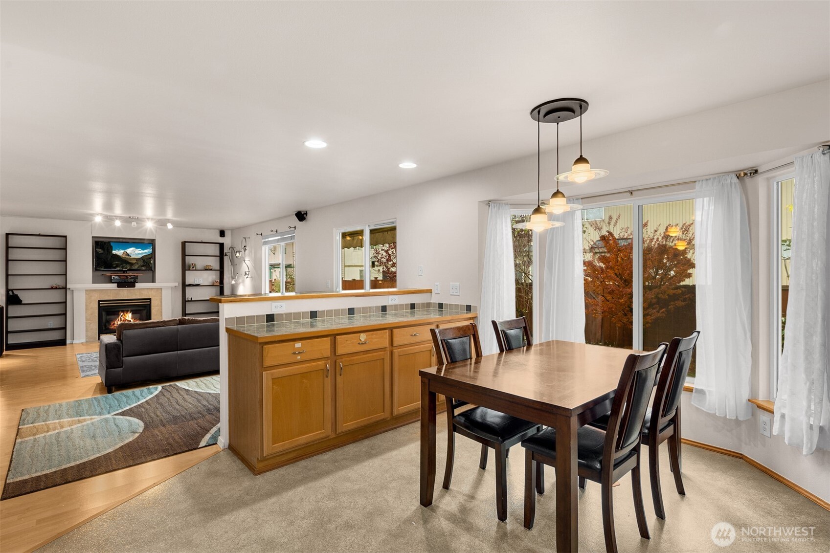2632 Northeast 24th Court Renton, WA 98056 - Photo 5 of 33 a kitchen with a dining table chairs and refrigerator
