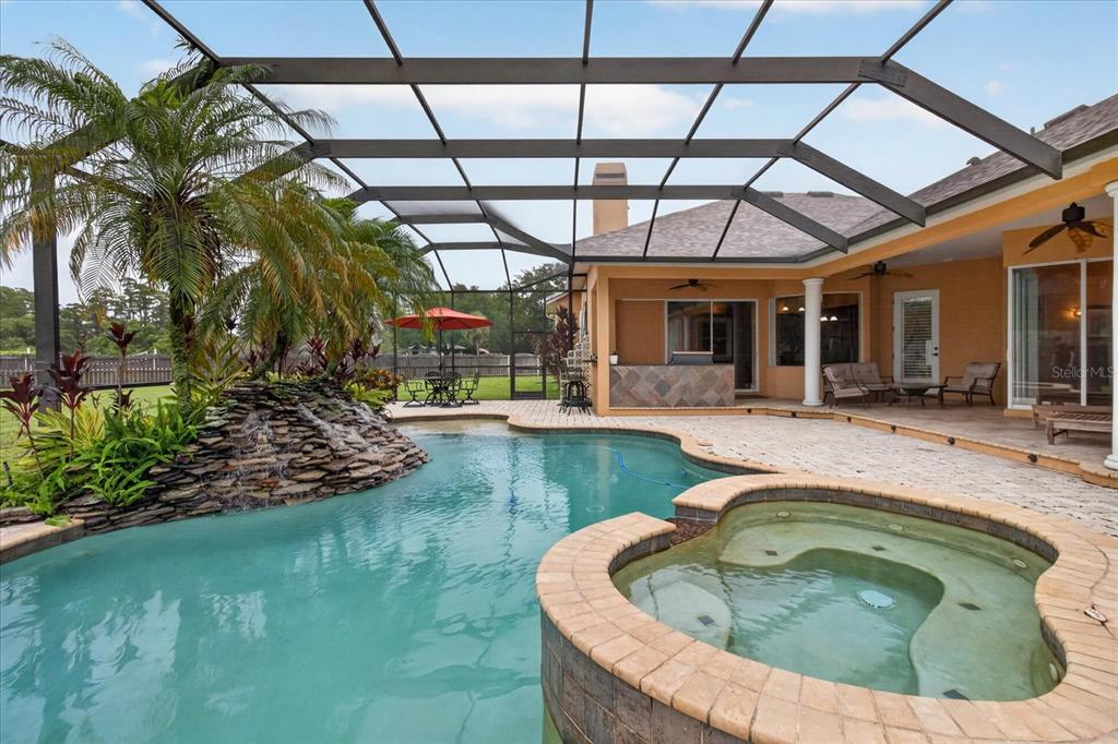 9427 Eddings Road Odessa, FL 33556 - Photo 73 of 93 a swimming pool with outdoor seating and yard