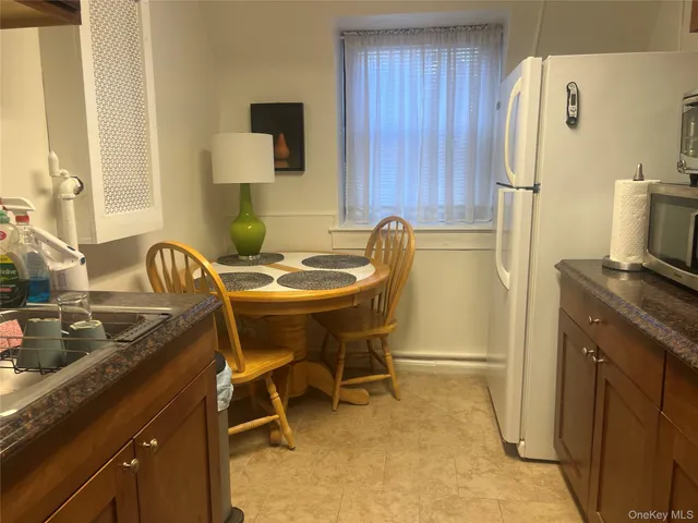 a dining room with furniture and a window