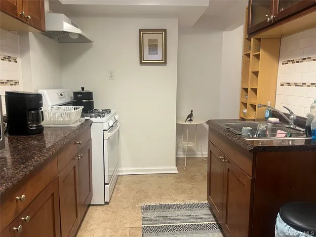 a kitchen with a sink stove and refrigerator