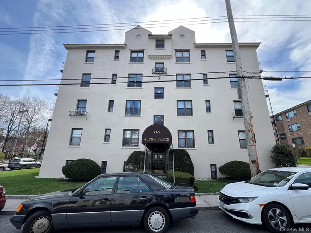 a front view of a building with parking space and parking space