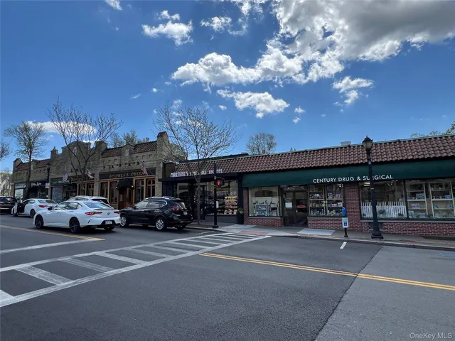 a view of a cars park in front of a building