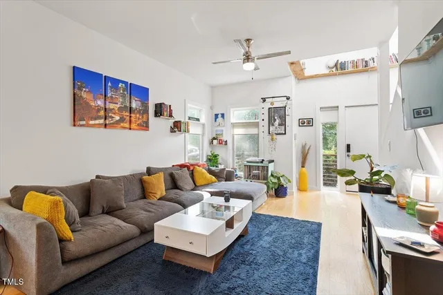 a living room with furniture and a chandelier