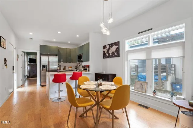 a dining room with furniture and a floor to ceiling window