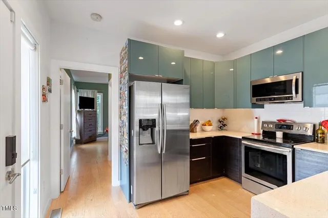 a kitchen with cabinets and stainless steel appliances