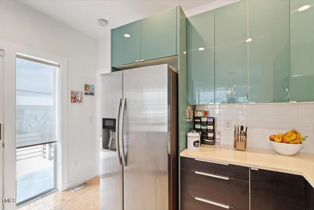 a kitchen with stainless steel appliances a refrigerator and a sink