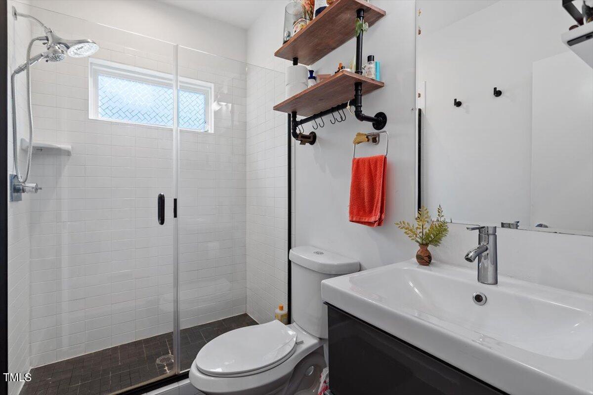 1314 South East Street Raleigh, NC 27601 - Photo 27 of 39 a bathroom with a sink toilet and shower