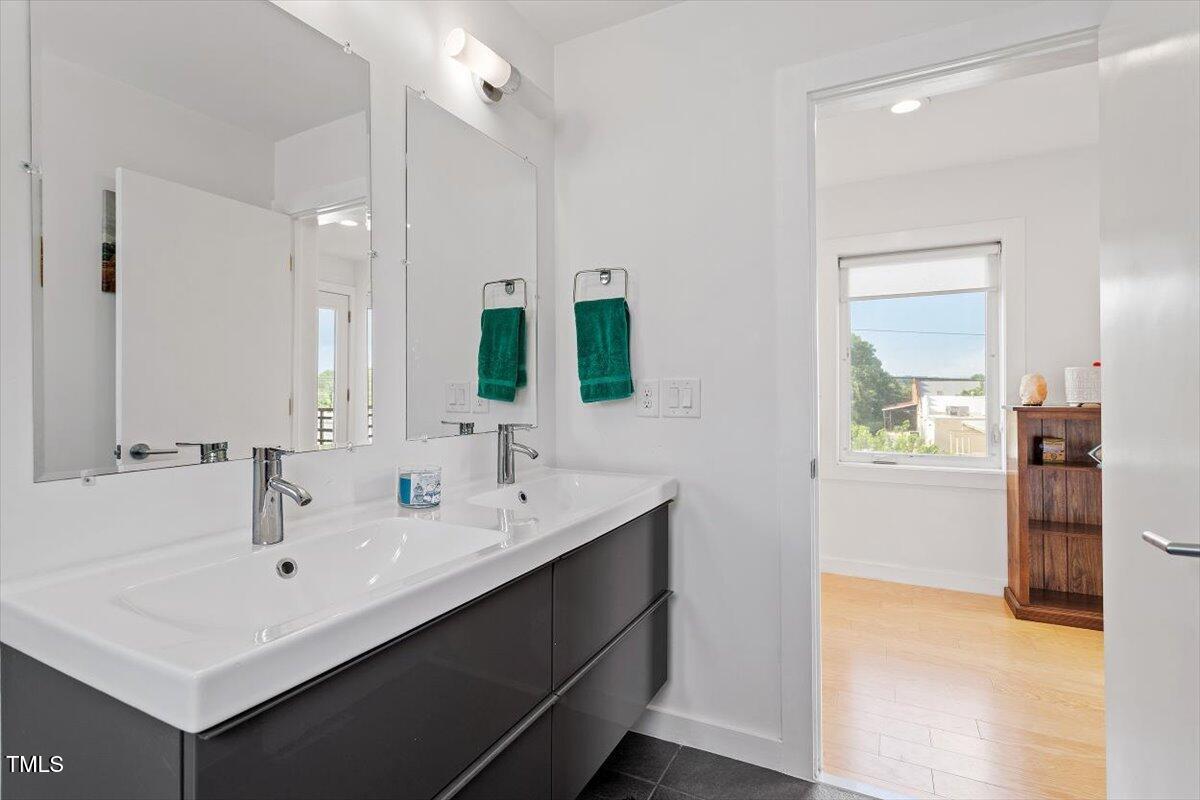 1314 South East Street Raleigh, NC 27601 - Photo 32 of 39 a bathroom with a sink and a mirror