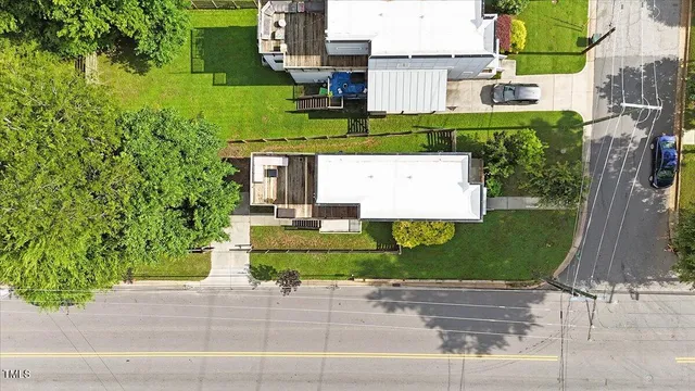 an aerial view of a house with a garden and parking