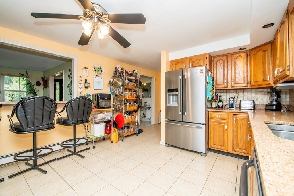 5 Chief Lane Canton, MA 02021 - Photo 12 of 42 a kitchen with stainless steel appliances granite countertop a refrigerator and microwave