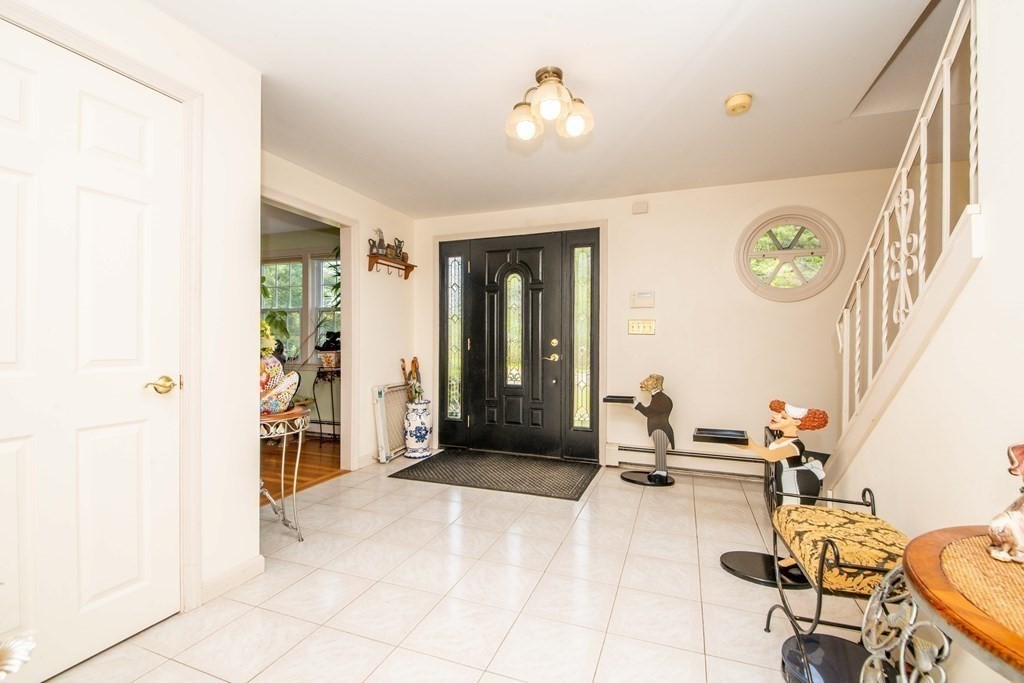 5 Chief Lane Canton, MA 02021 - Photo 28 of 42 a living room with furniture a clock and a window