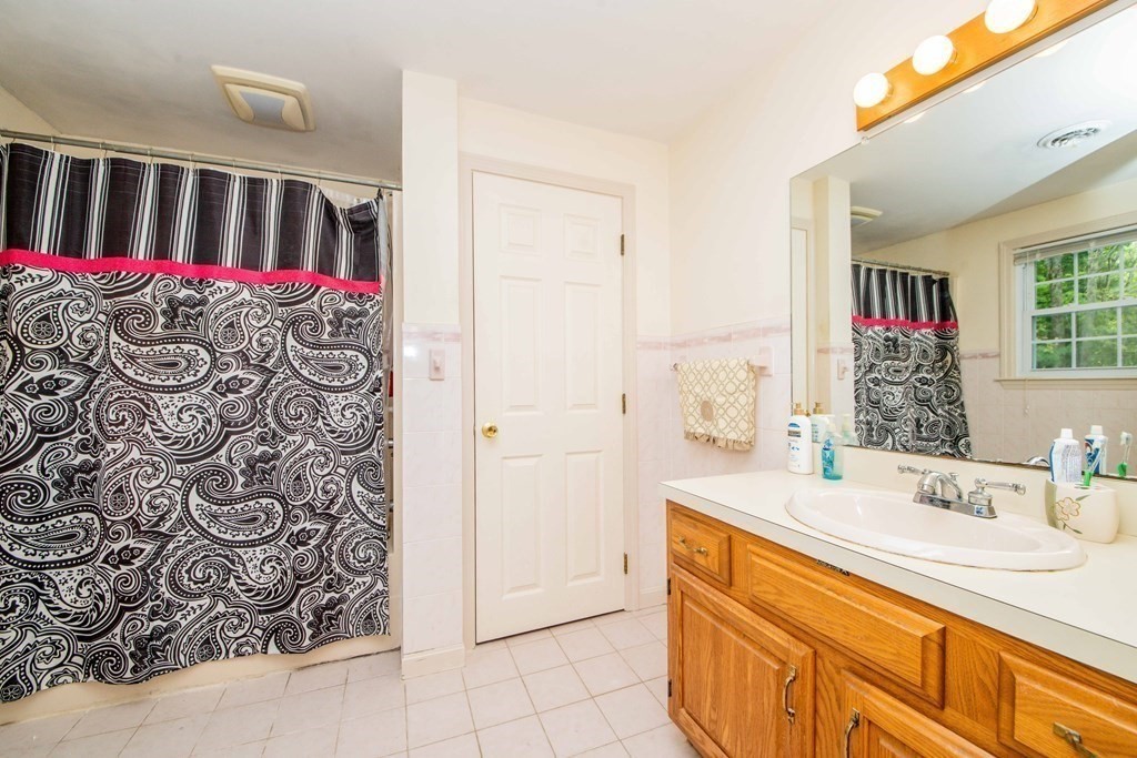 5 Chief Lane Canton, MA 02021 - Photo 29 of 42 a bathroom with a sink and a mirror