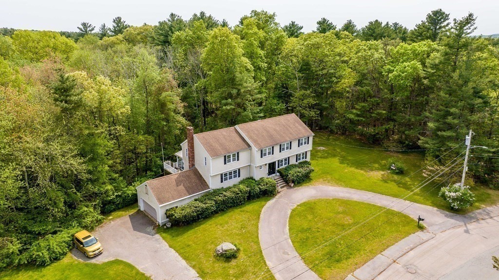 5 Chief Lane Canton, MA 02021 - Photo 5 of 42 an aerial view of a house with swimming pool and trees in the background